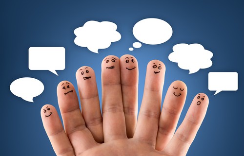Happy group of finger smileys with social network sign and icons on blue background
